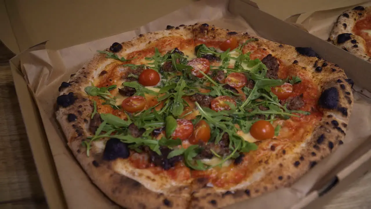 shot of delicious Italian pizzas delivered in boxes on the table in 4k