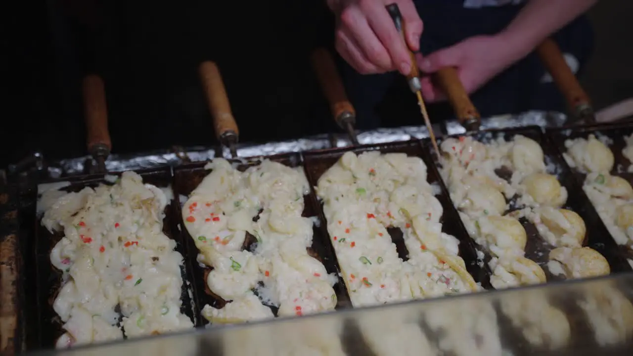 Japanese Takoyaki Octopus Dumplings being cooked on streets of Osaka