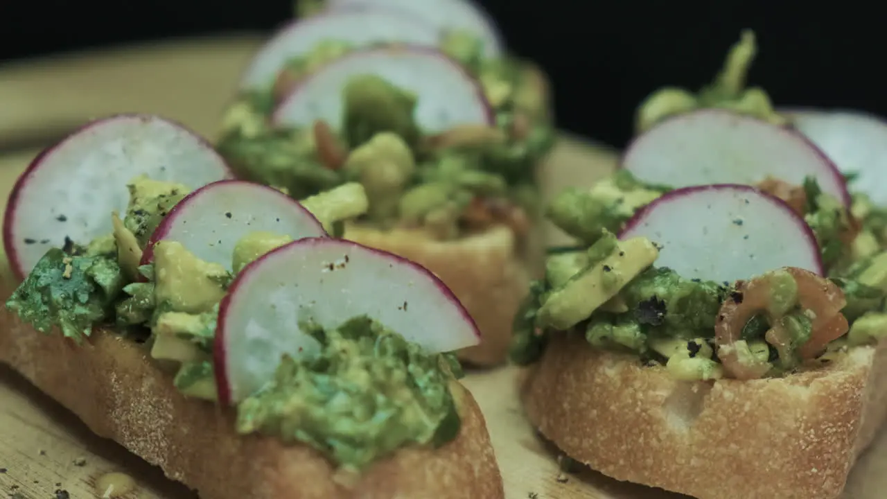 Vegan Brunch Avocado on Sourdough Toast with Radish and Coriander on a spinning plate