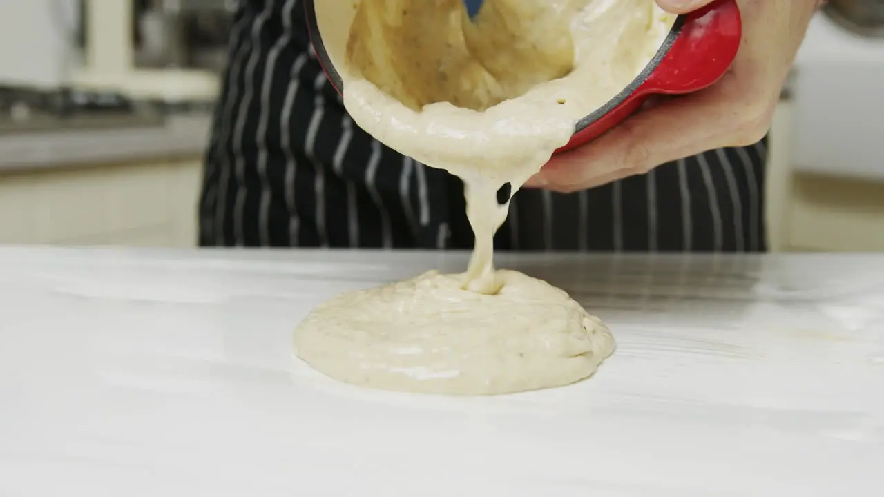 Chef takes out bone marrow steak sauce onto the kitchen table