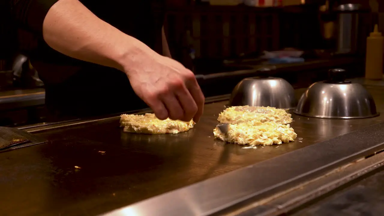 4K Japanese chef prepares 3 Japanese pancakes on a hot plate