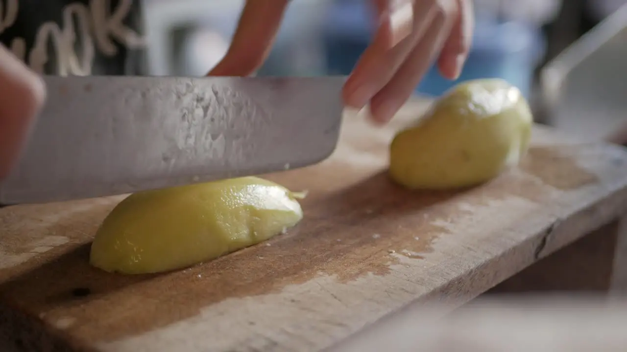 cutting fresh potato on wooden cutboard