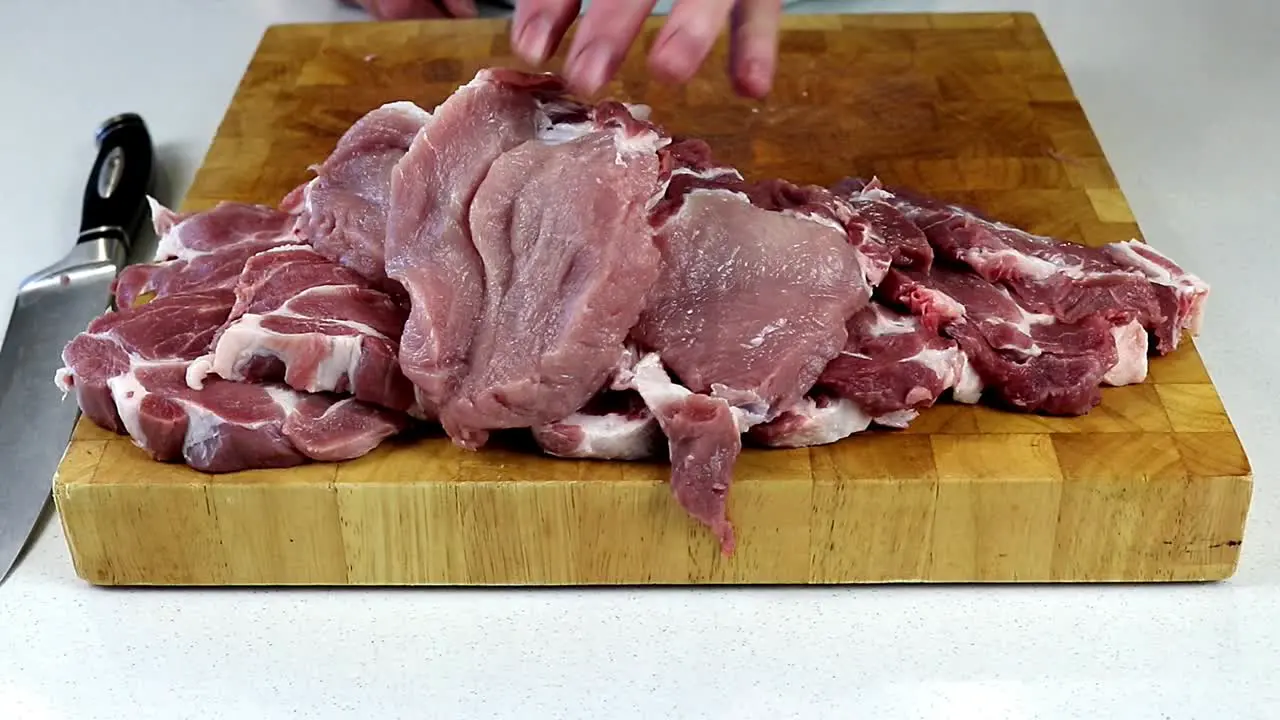 Arranging Freshly Cut Pork Meat Slices