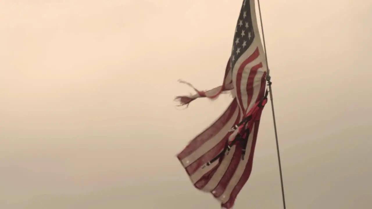 American Flag ripped against dark sky