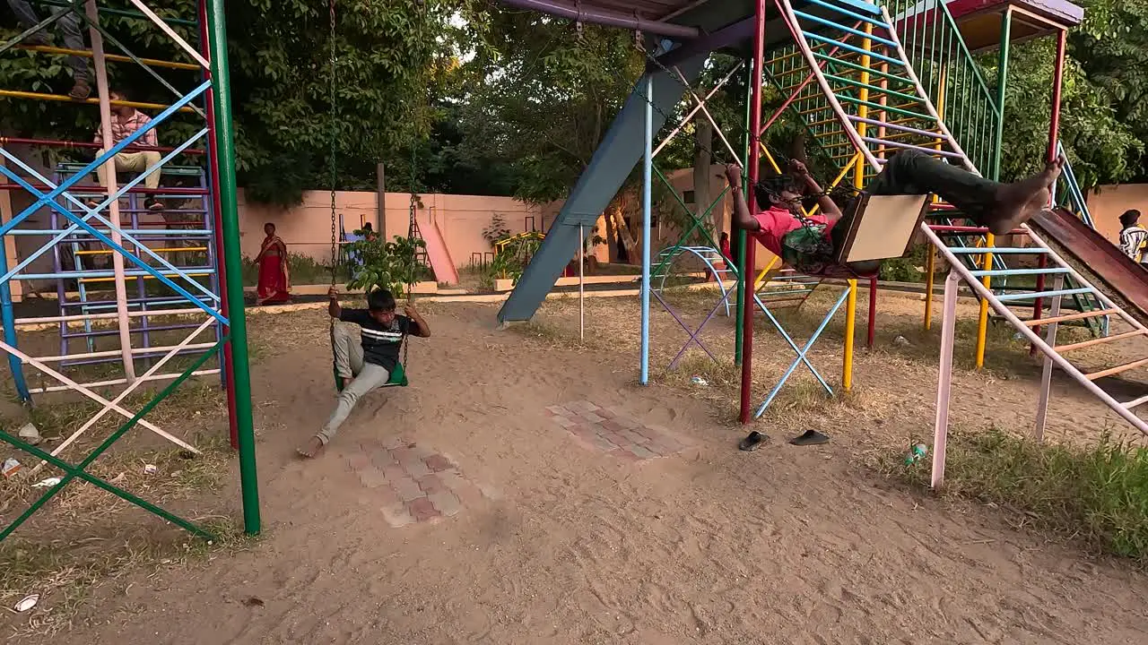 A public park where two children are having fun with the help of a slide