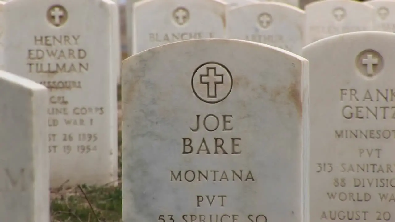 A Closeup Tracking Shot Of The Inscriptions For Both Men And Women Buried In Arlington National Cemetery