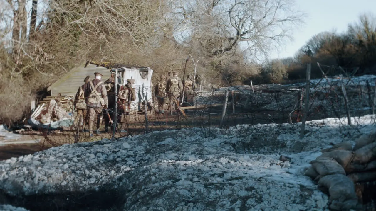 World War 1 soldiers marching across a battle field of tenches in the winter