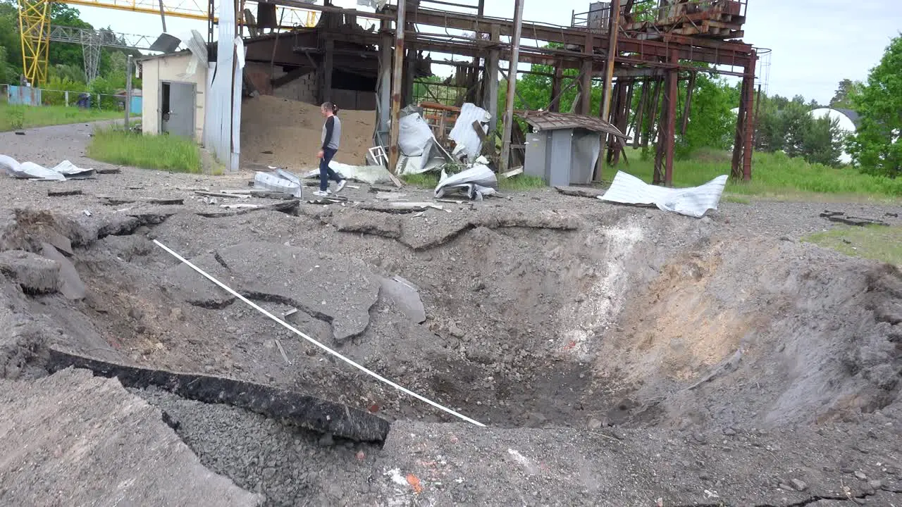 People Inspect A Huge Bomb Crater From A Russian Missile Or Rocket Attack On Kyiv Ukraine