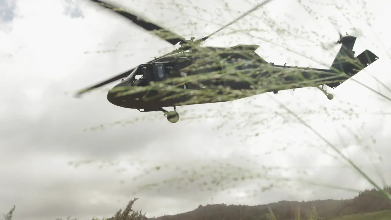 A large helicopter lifts off the ground into a cloudy sky