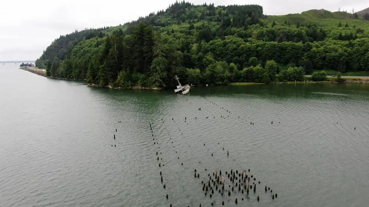 Aerial shot approaching shipwrecked USS Plainview boat in Columbia River bay