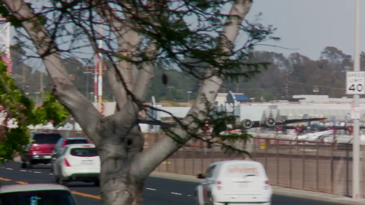 A vintage airplane takes off from an airport