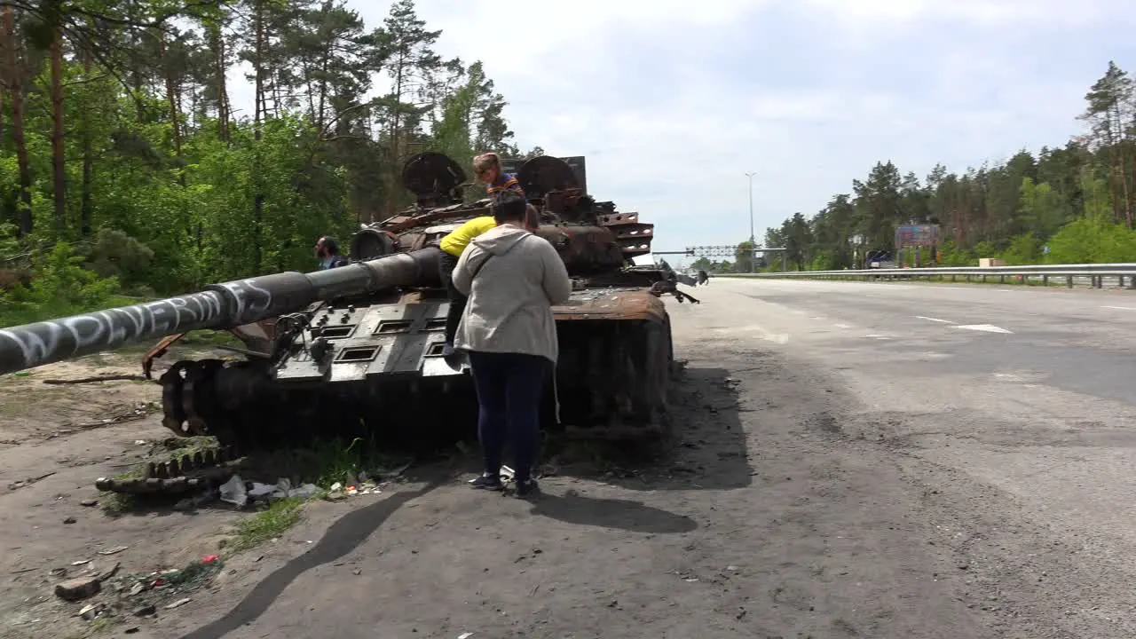 Chldren Play On An Abandoned Russian Tank Along A Highway Into Kyiv Following The Russian Invasion