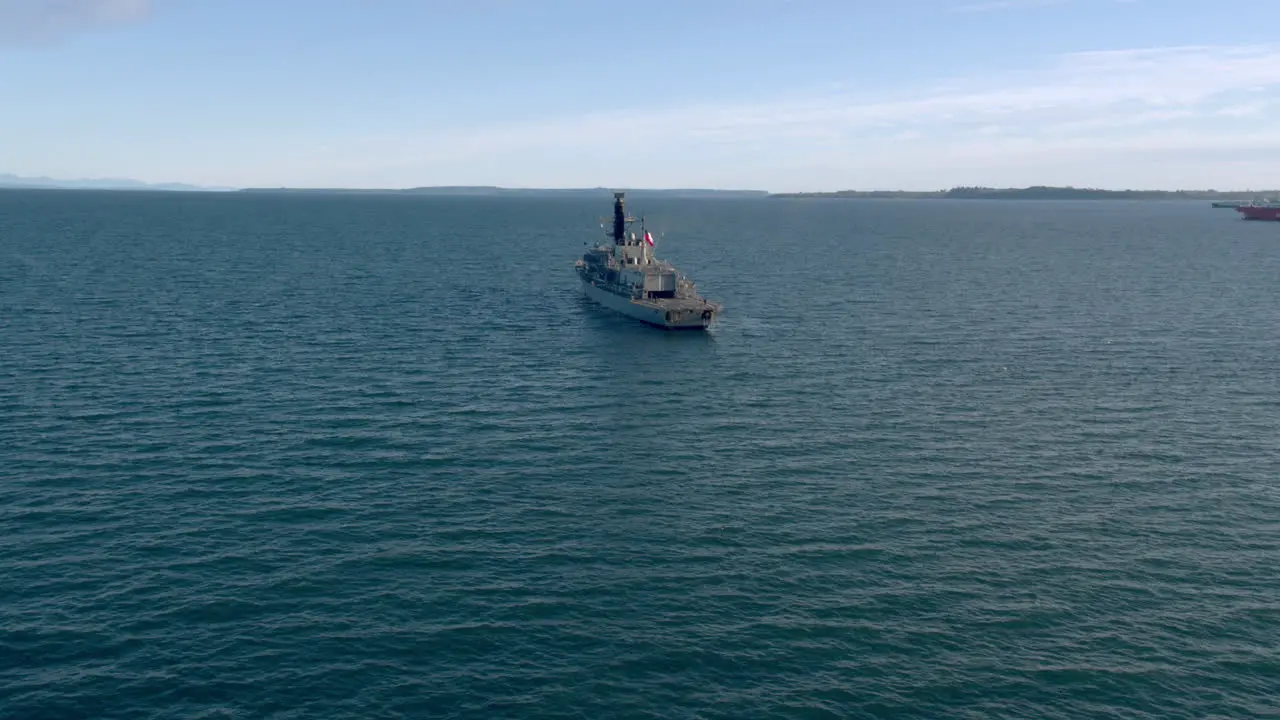 Aerial View Around Stern Of Chilean Navy Frigate Travelling Through Puerto Montt Bay