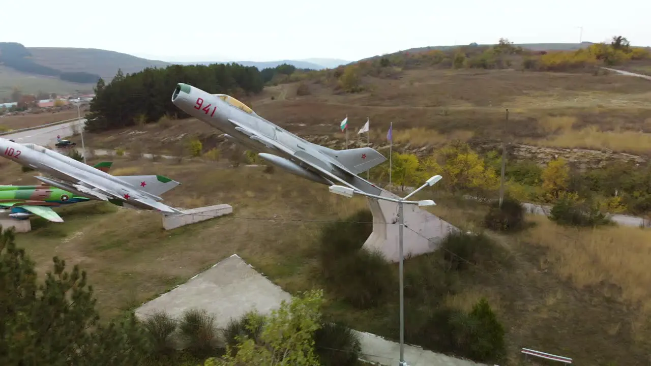 Aerial arc footage of military airplanes outdoor museum exhibition