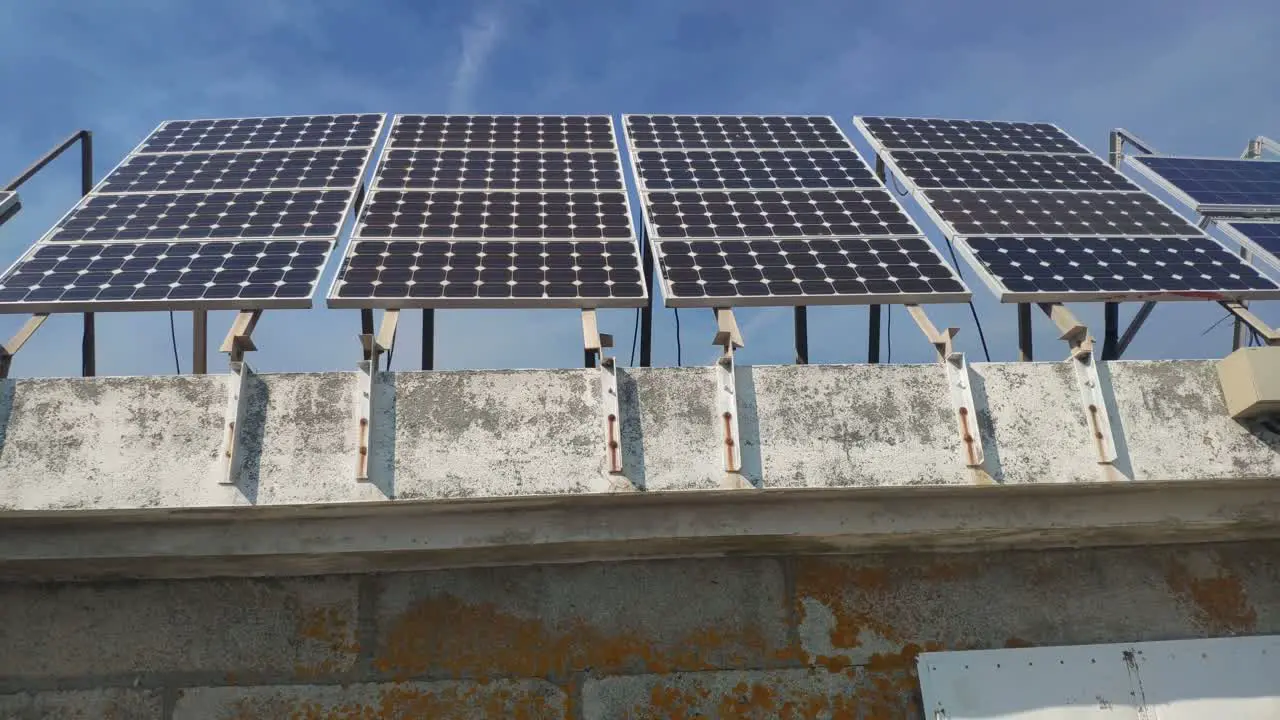 Solar panels lined up in the ecological building in the natural park biosphere reserve with the sunny sky in the background front shot traveling sideways