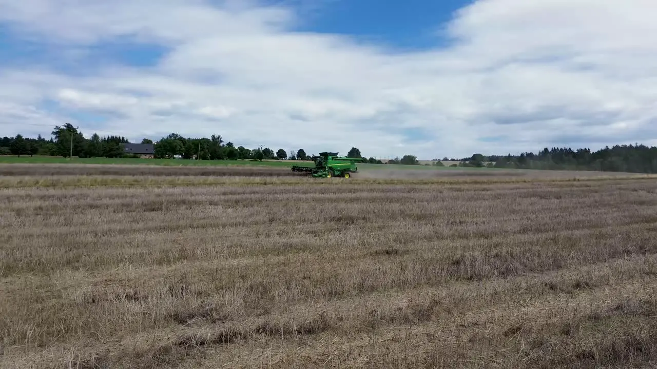 A view of efficient combined harvesting in action when the camera from the drone and rotates around it