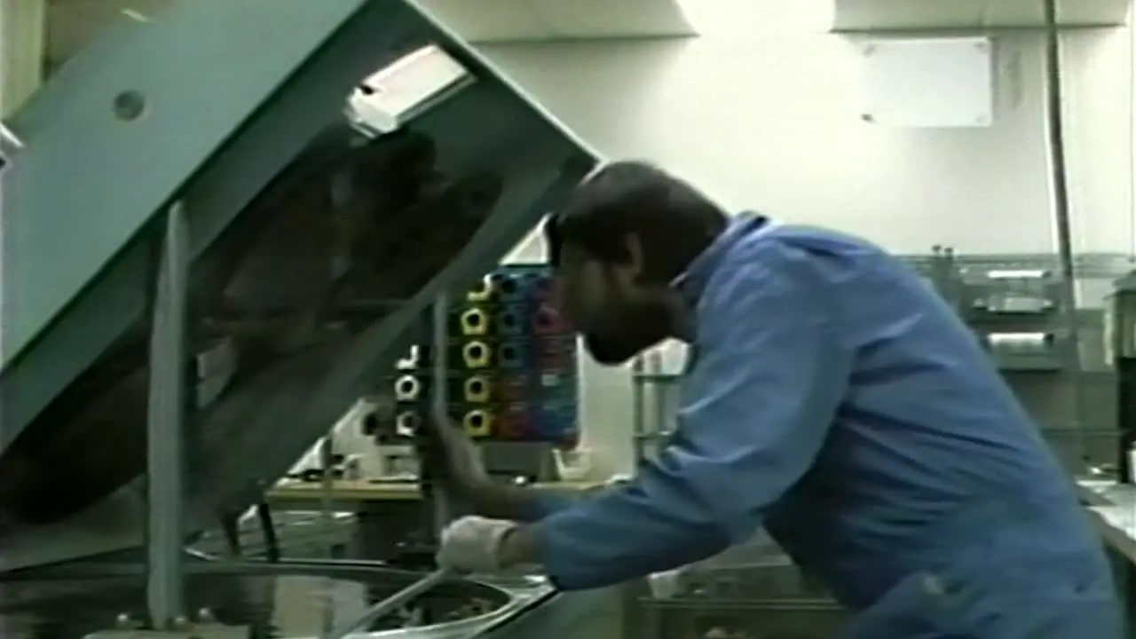 1980S TECH WORKING ON SILICON WAFER CHIP