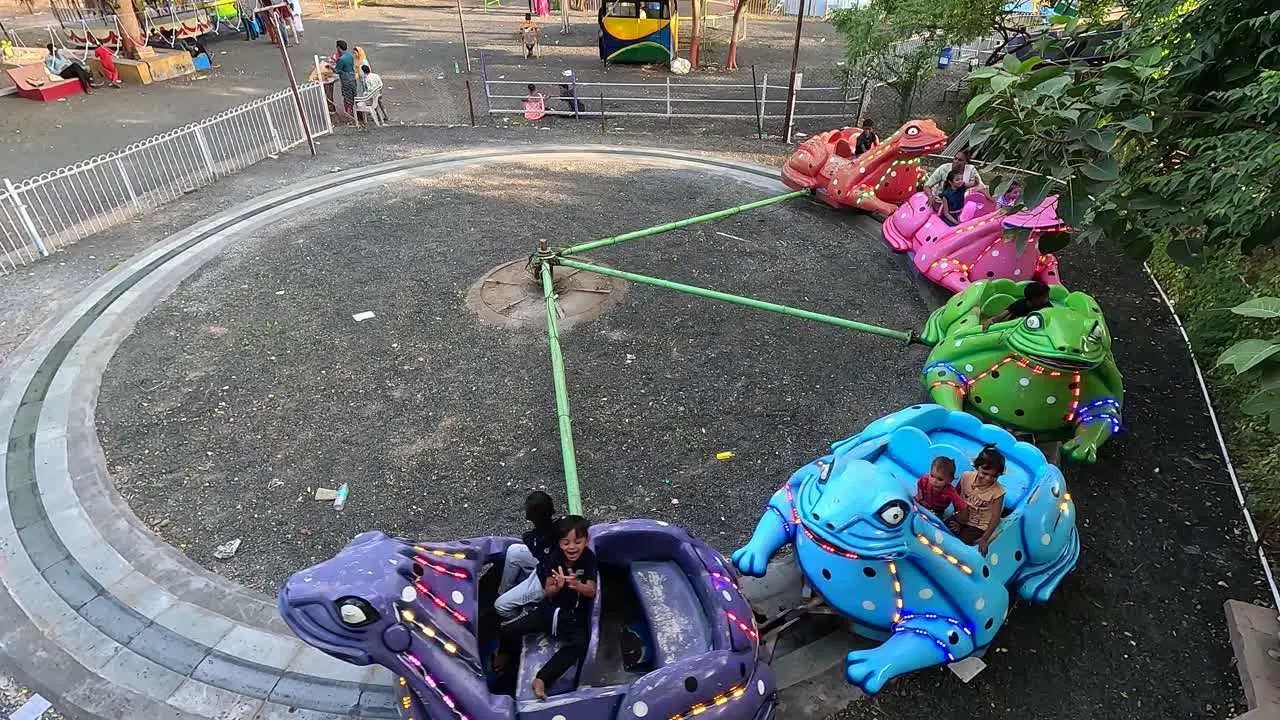 A scene from above showing young children enjoying the whacky frog ride