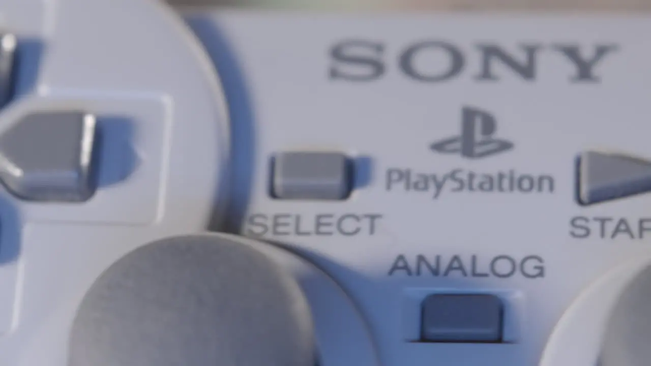 Buttons on Vintage Playstation Controller in Blue Light SLIDE RIGHT