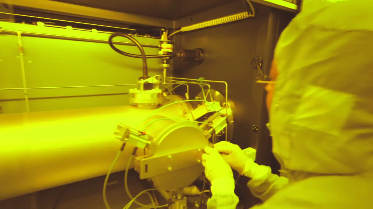 Technician in laboratory clean room working on a pipe Dolly