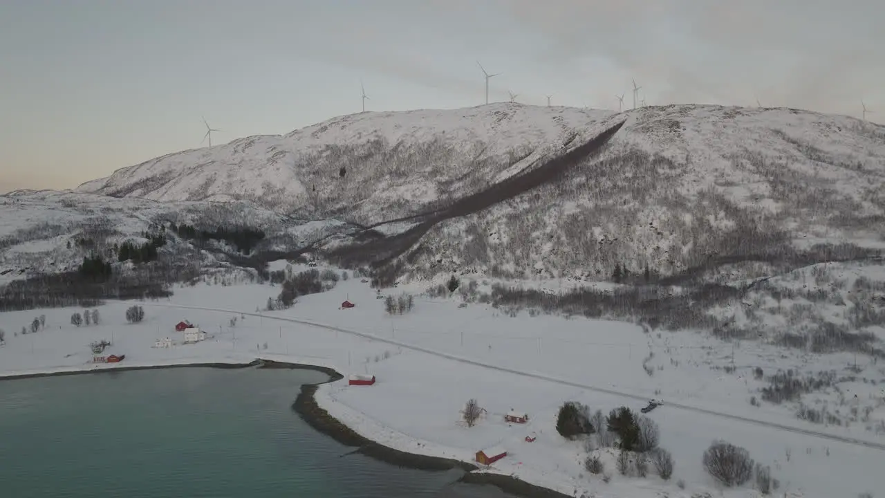 Wind Turbine Field At Top Of Snowy Norwegian Hills Landscape Aerial