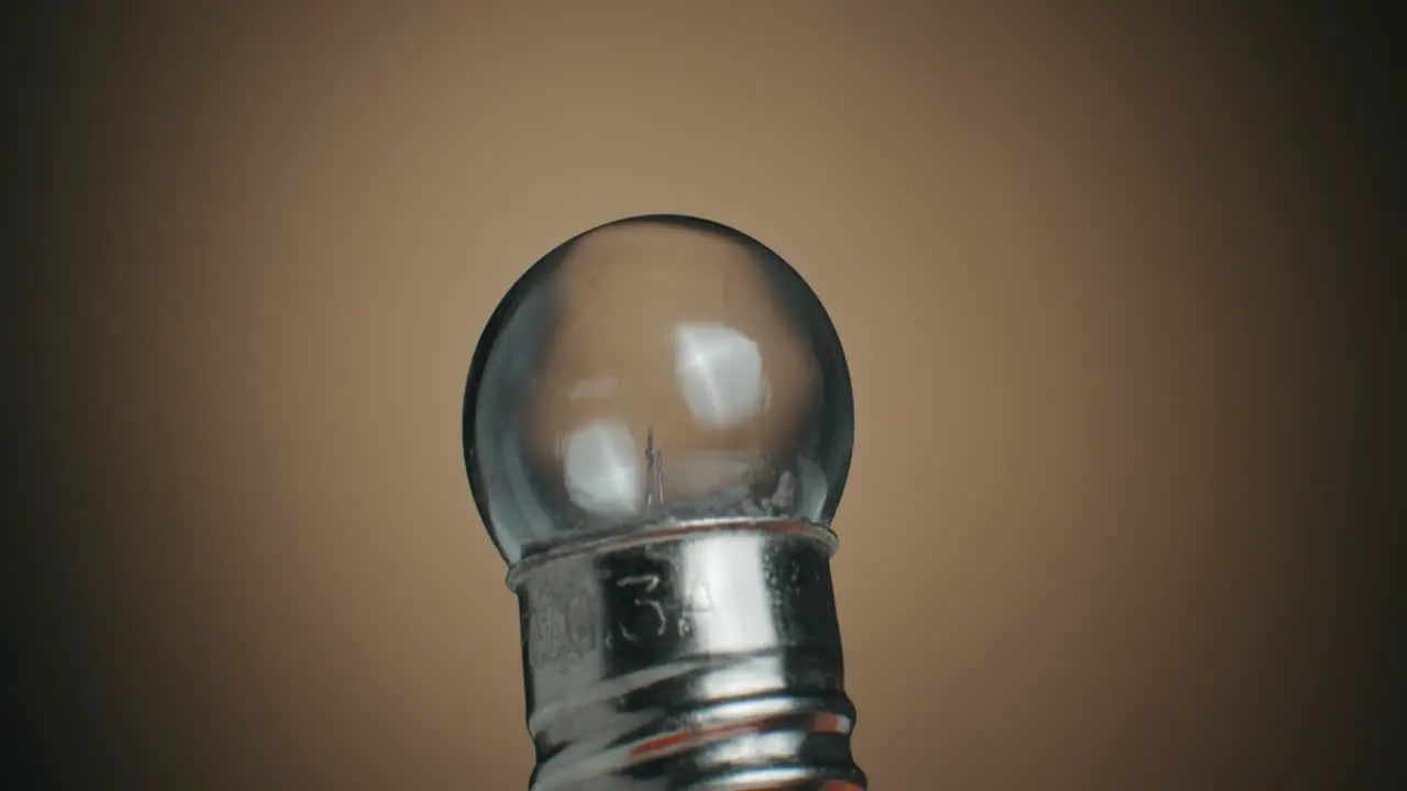 Extreme Close up of a Tungsten Filament Light Bulb and Macro Shot of Electronic Components on Turn Table