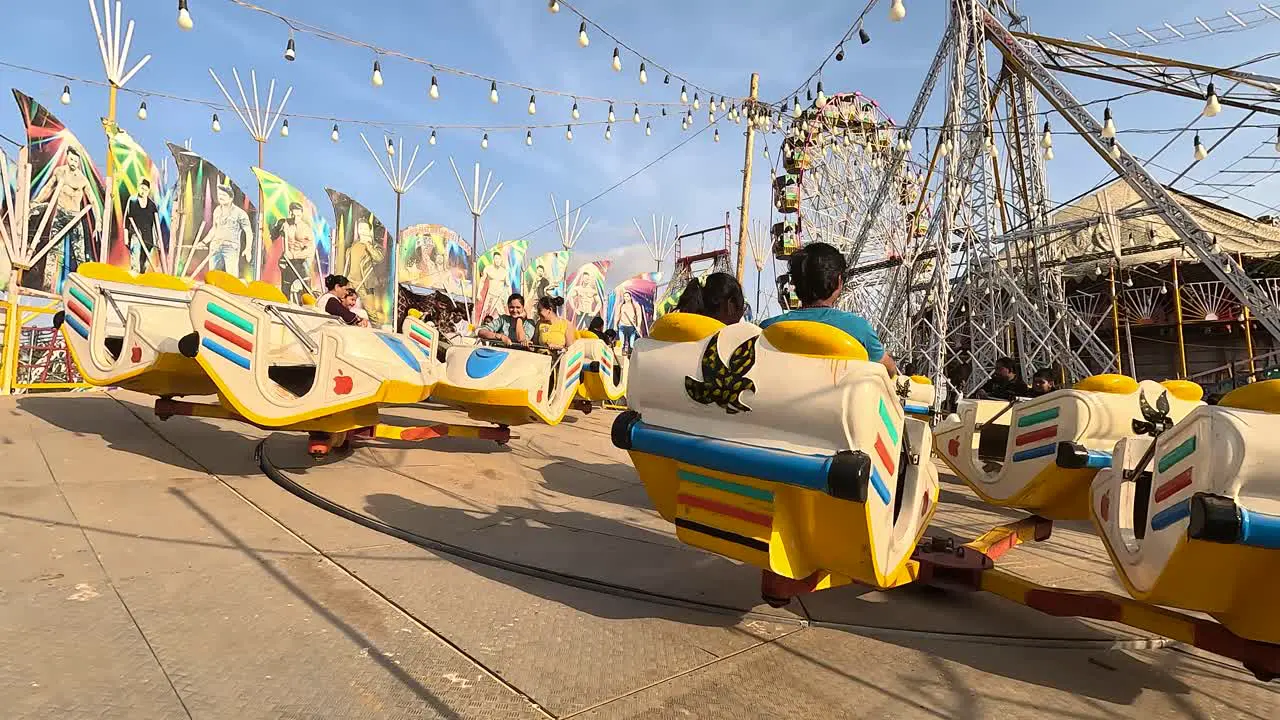 Break dance ride scene in daytime amusement park with couples enjoying