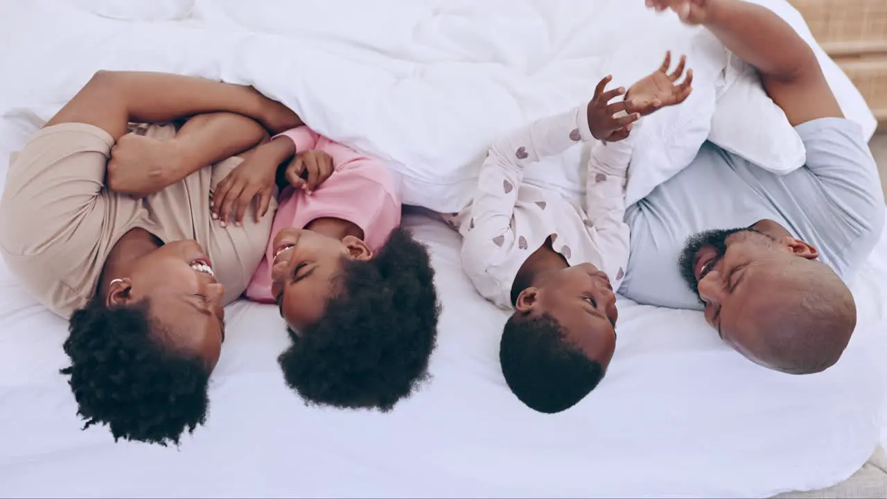 Love top view and happy black family in a bed