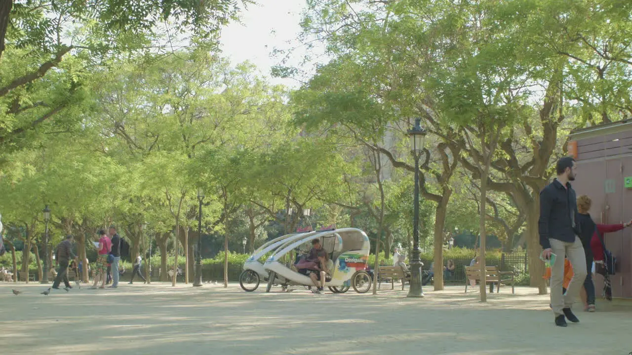 Tourists Walking In A Park Of Barcelona Spain