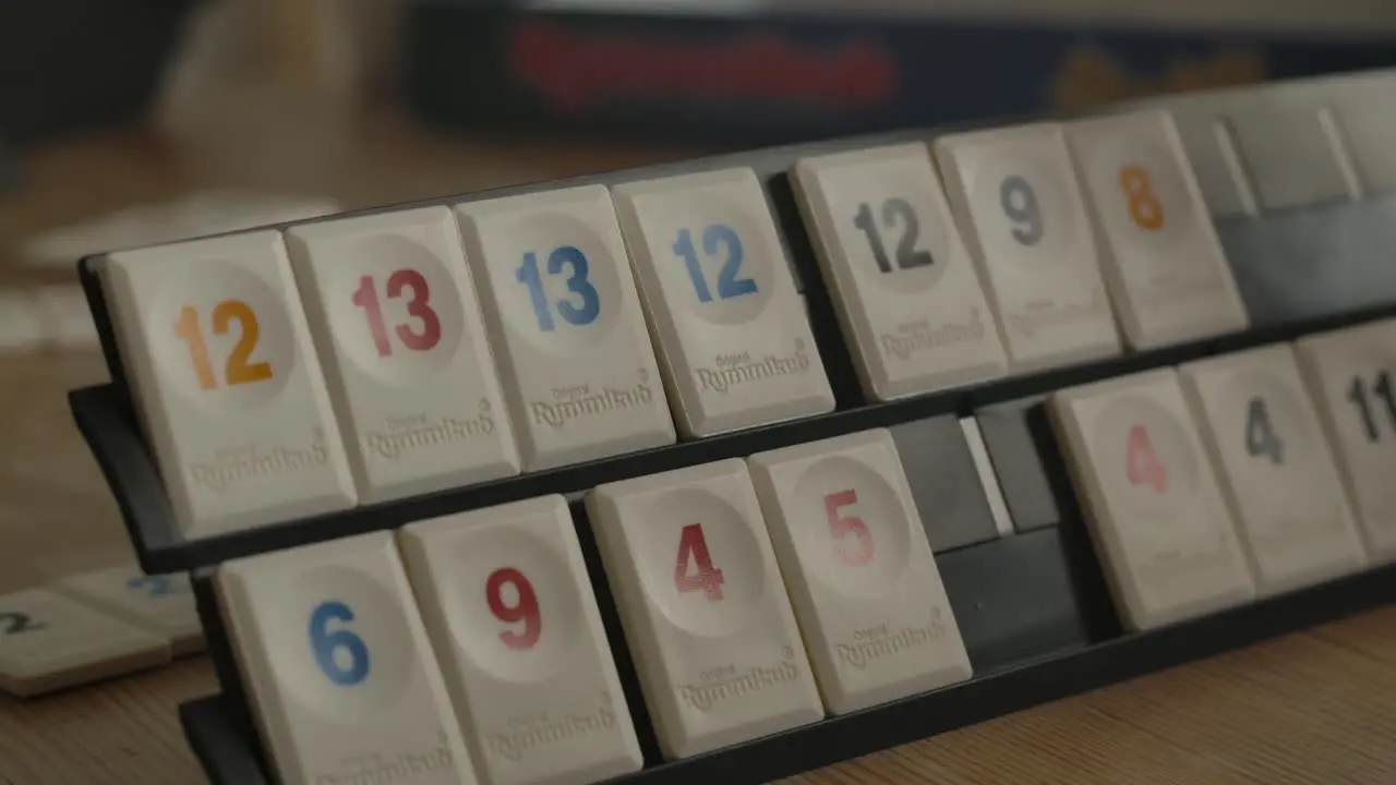 Close up view of person playing Rummikub filmed handheld in 4k