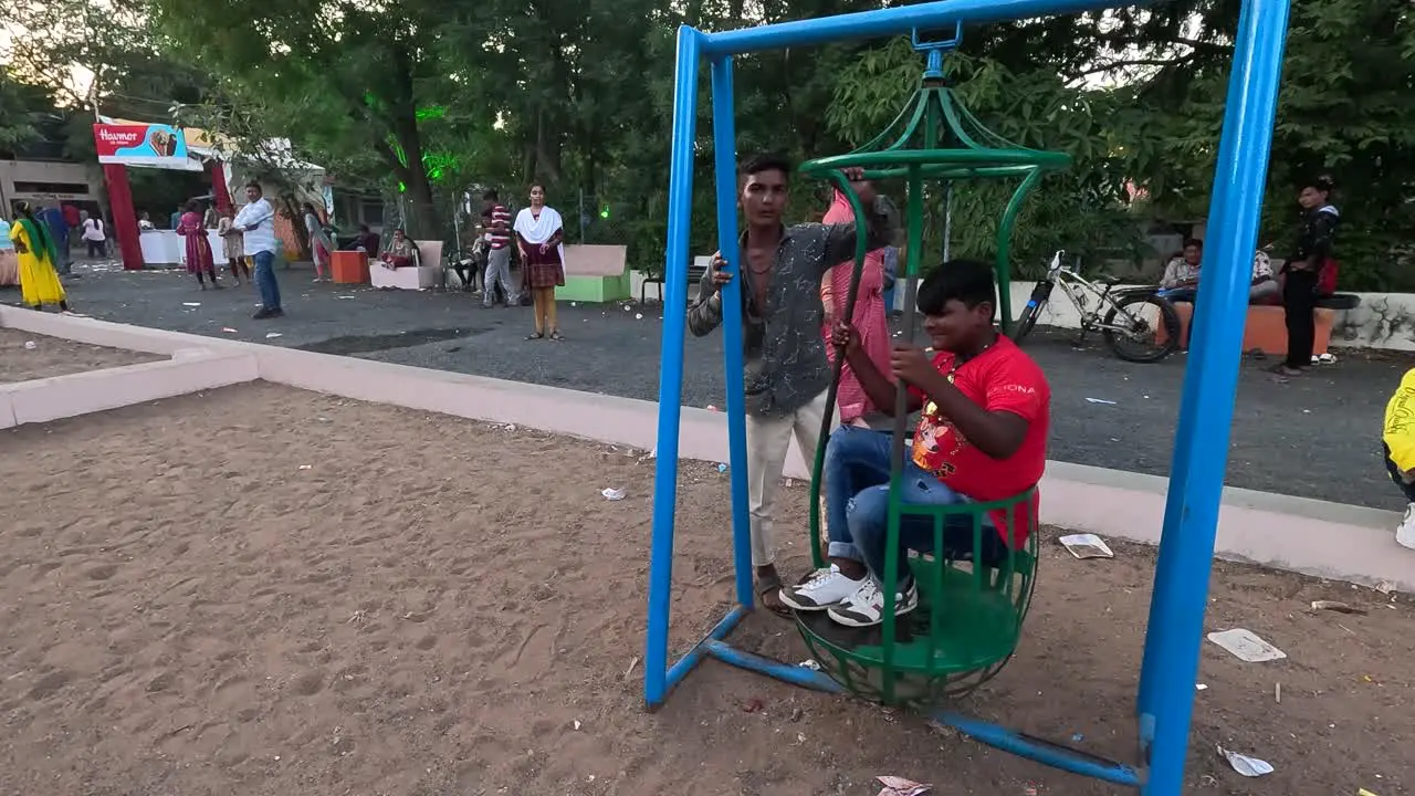 One child is making the other child enjoy the vacation by turning him sideways