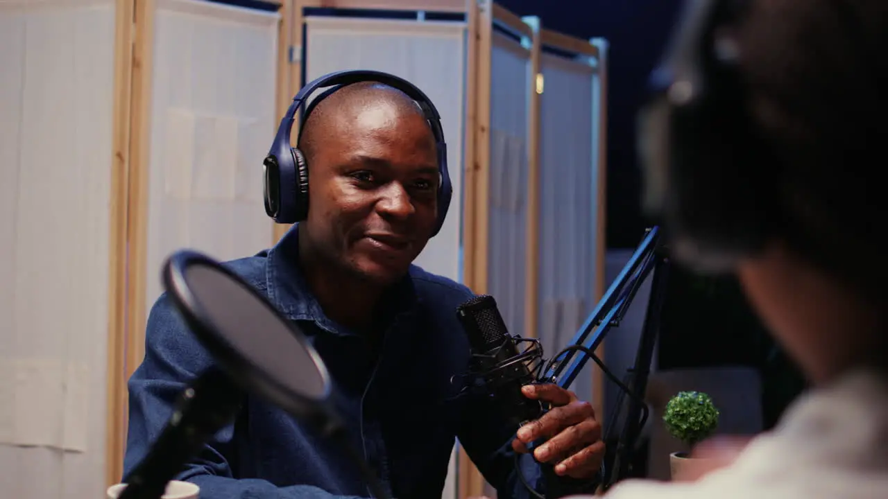 Man recording podcast using high tech audio equipment to interview guest