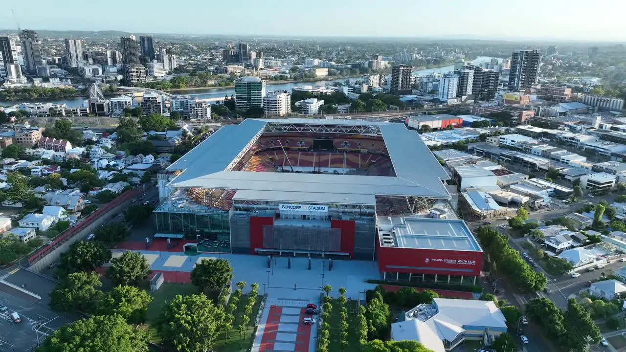 Aerial drone shot flying towards Brisbane's Suncorp Stadium with stunning aerial views of inside the stadium where workers are preparing for a music concert