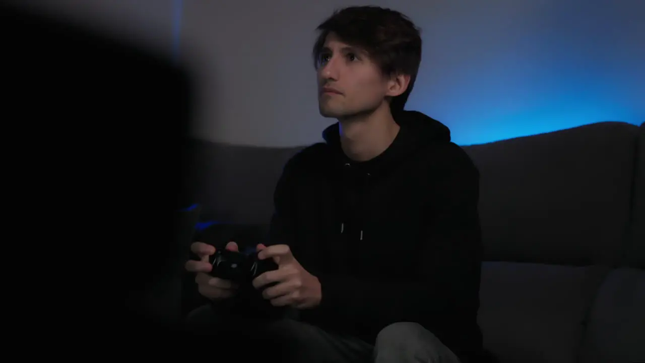 Young Man On Couch Playing Video Games Medium Shot