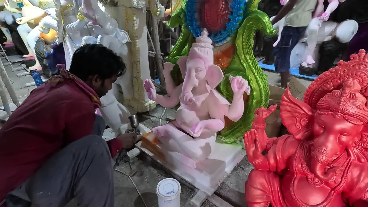 Front view an artist making an idol of Lord Shri Ganesha with his hands Happy Ganesh Chaturthi