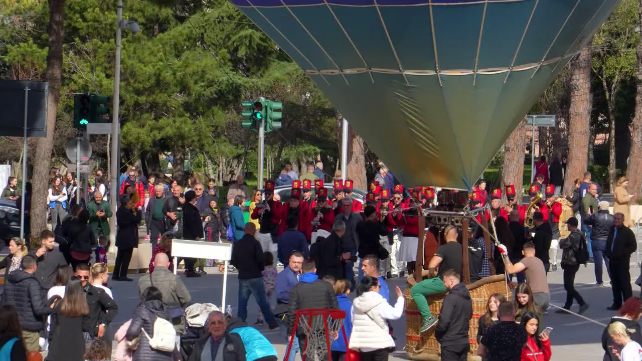 Colorful Spring Day Festivities in Tirana People Celebrating with a Brass Band and Balloons in the Air