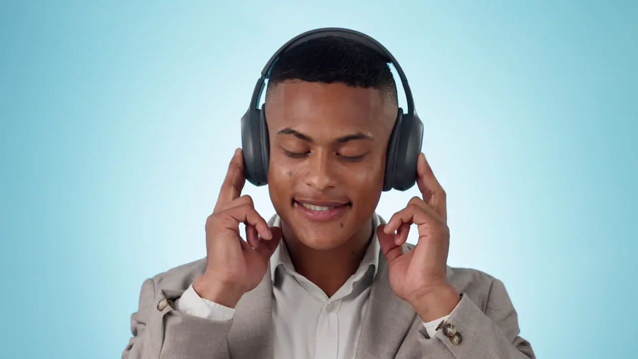 Headphones move and young businessman in a studio