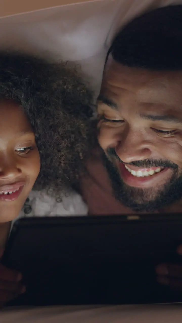 Night tablet and father with boy in bed