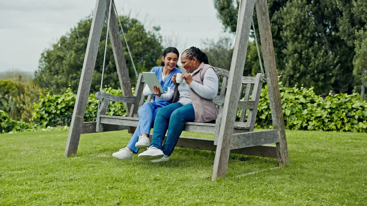 Happy woman nurse and patient on tablet at park