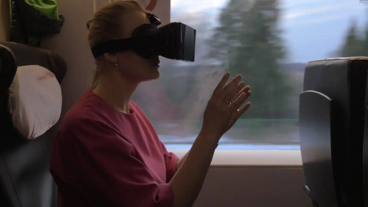 Woman using VR-headset during train journey