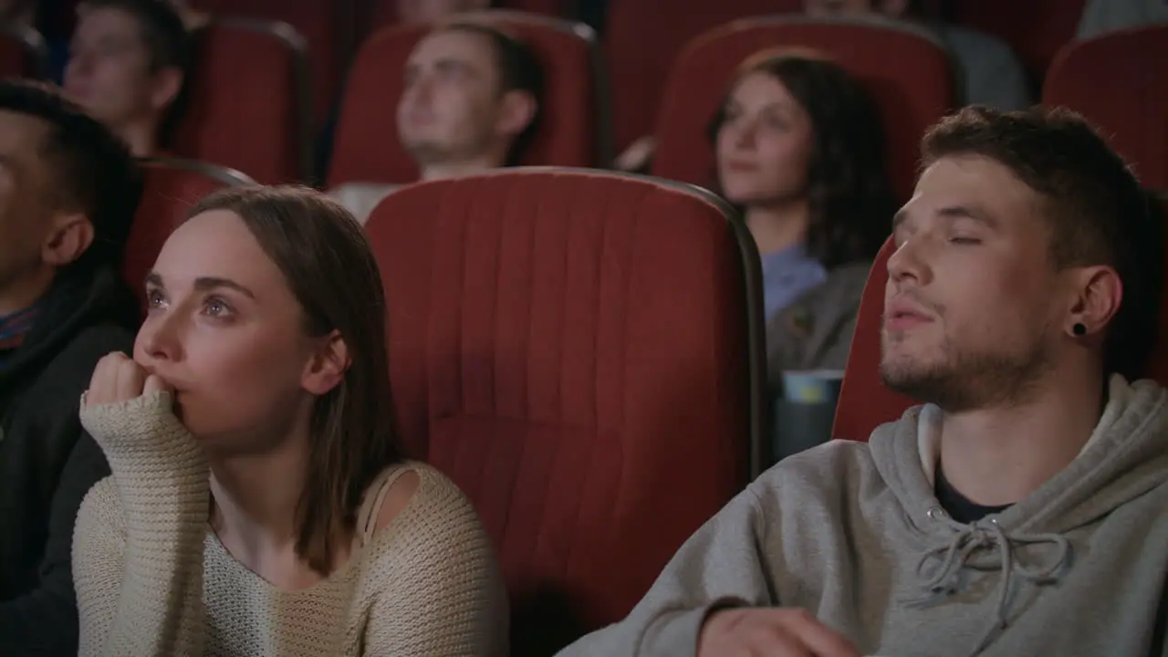 Man hugging woman in the cinema theater