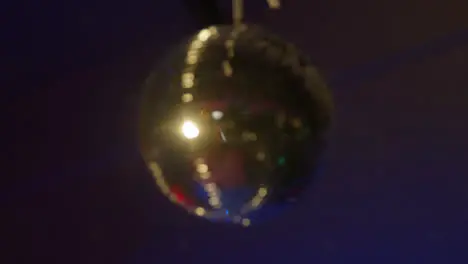 Shot Of Defocused Mirrorball Slowly Revolving In Night Club Or Disco