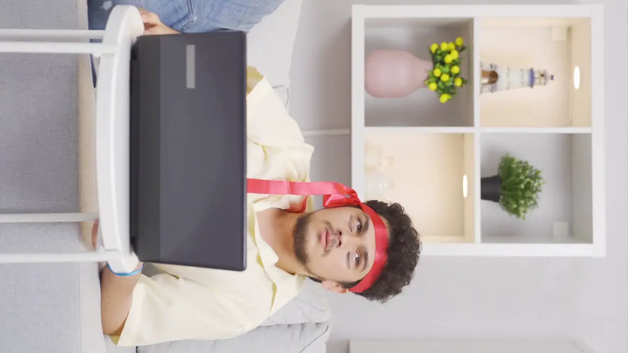 Vertical video of Funny man is thoughtful while working on laptop