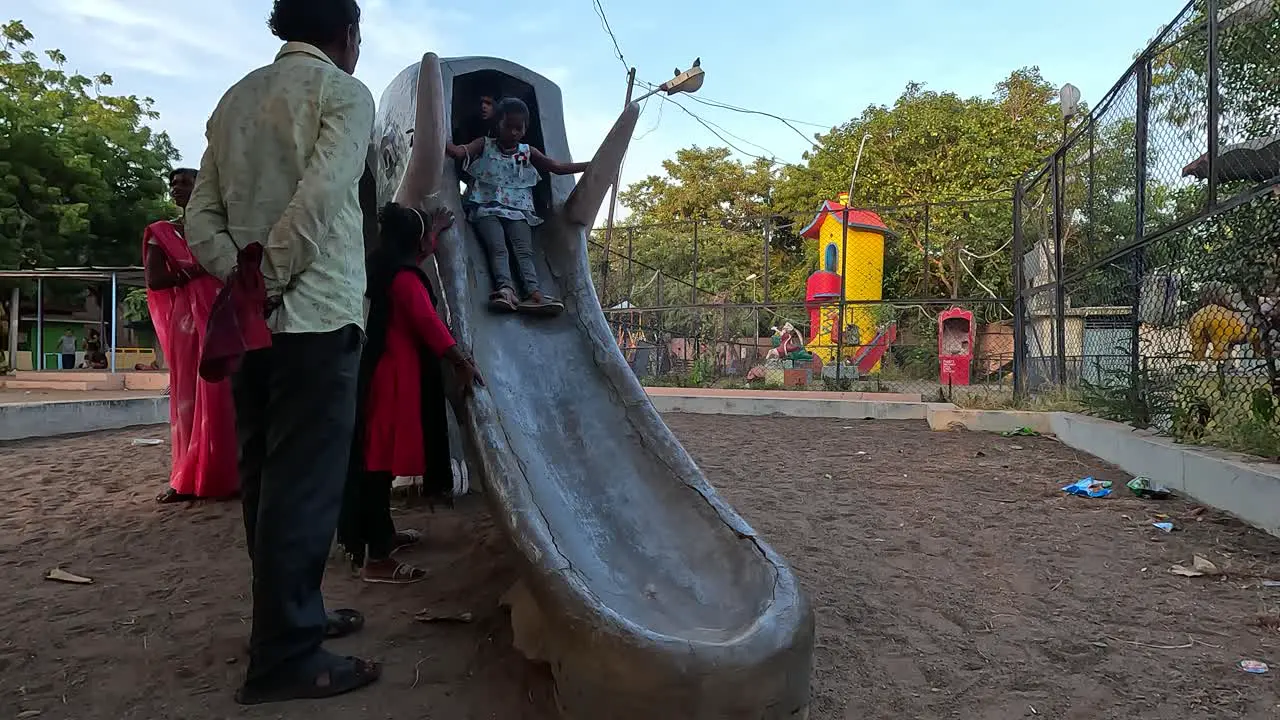 Little kids are enjoying the sliding ride with their parents