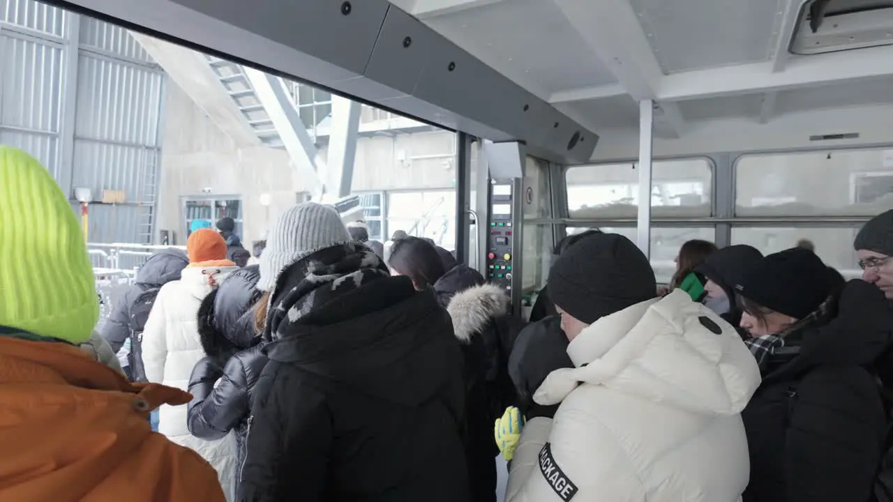 Tourists Getting Off Zugspitze Gondola In Winter In Grainau Germany