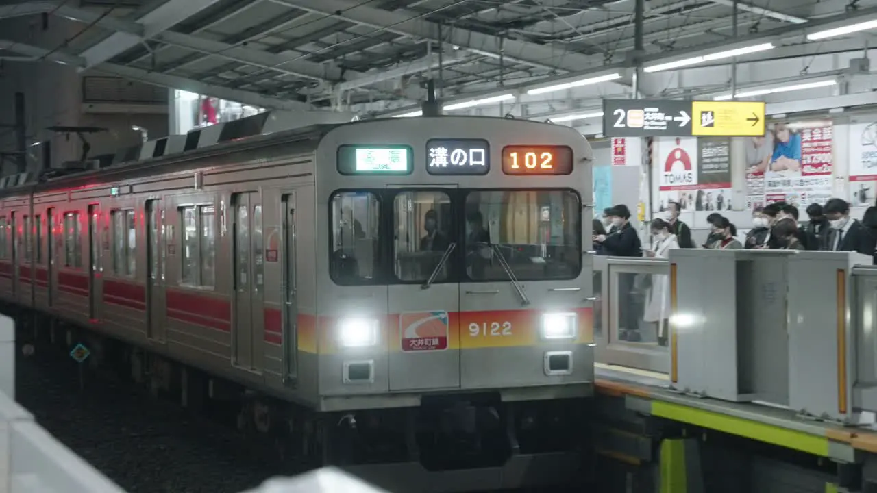 Train With Passengers Approaching The Platform Of Station In Tokyo Japan