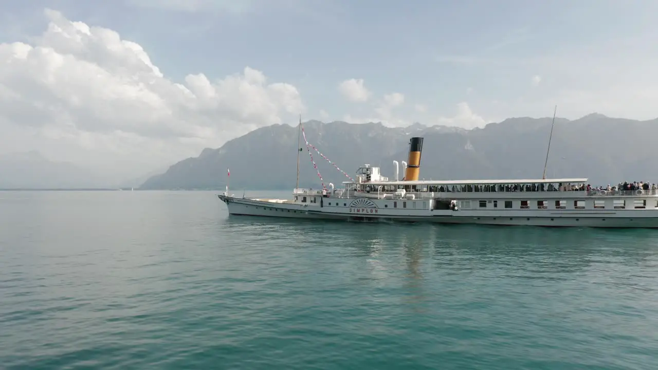 Dynamic Aerial of beautiful cruise ship driving over Lake Geneva on a sunny summer day