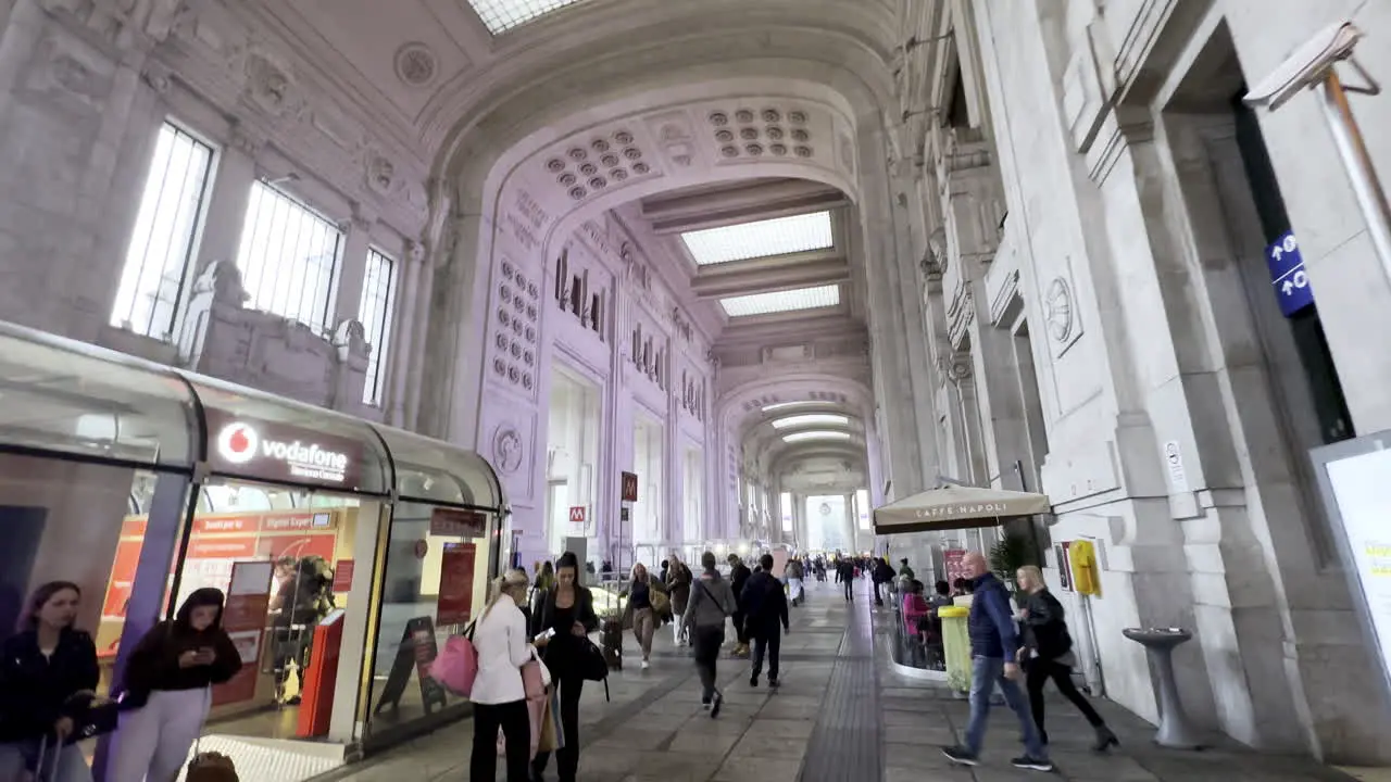 Tourists and travellers walking inside Milan Central train station