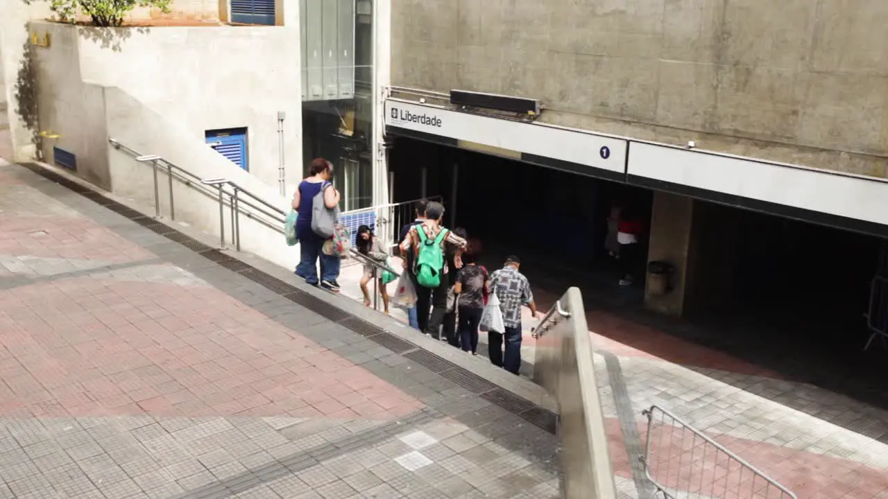 People coming and going at the entrance and exit of the subway station in the Japanese neighbourhood of Liberdade in São Paulo Brazil