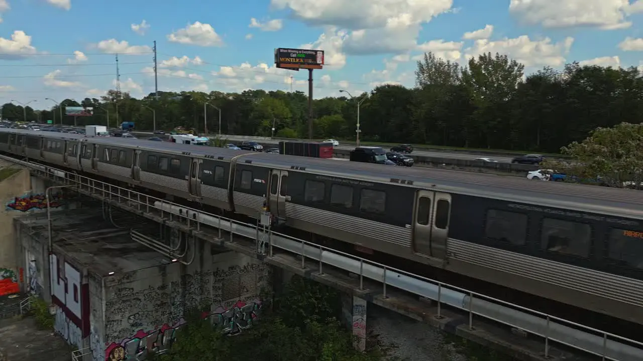 Passenger train drives at high speed parallel to expressway Downtown Atlanta Georgia USA